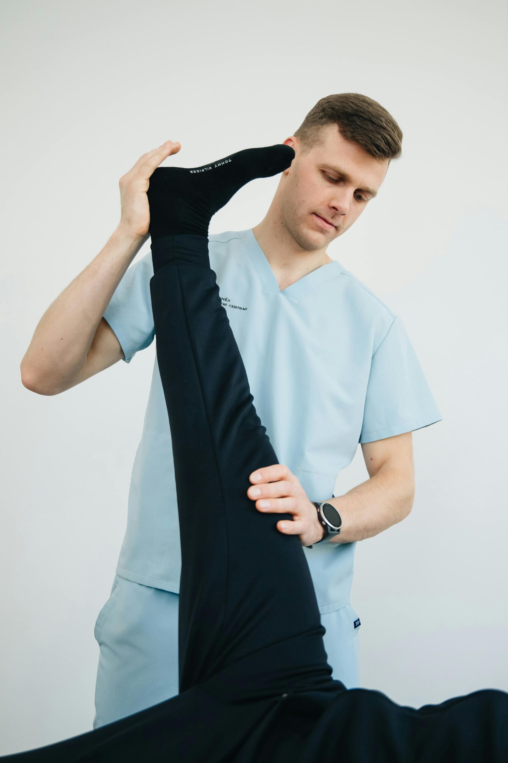 a therapist raising a leg